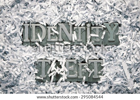 identity theft phrase made from metallic letterpress type inside of shredded paper heap