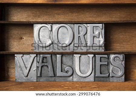 core values phrase made from metallic letterpress type on wooden tray
