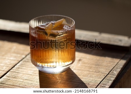 Old Fashioned Cocktail with clear ice cube on wooden background 商業照片 © 
