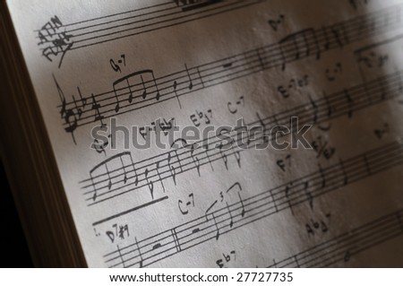 Music sheet hand written  slightly lit with shallow depth of field