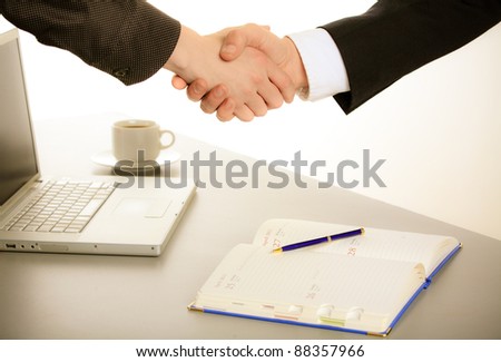 Photo of handshake of business partners after striking deal. Closeup.