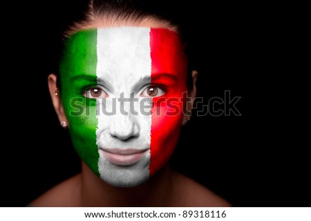 Portrait of a woman with the flag of the Italy painted on her face.