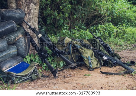 Military equipment, weapons , ammunition, backpacks , hats , military shelters , a military camouflage mesh texture picture day border war sandbag bunkers on the mountain .