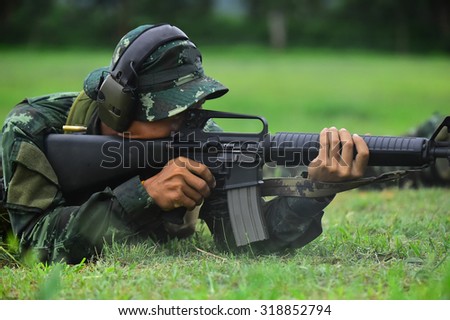 Military Gun M16, firearms, ammunition , smoke gun battle in a meadow in the woods sound landscape , military rifles , green backdrop .