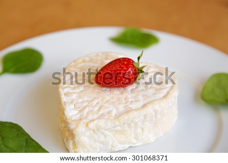 heart shaped cheese with lettuce and strawberries