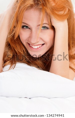 Closeup portrait of a cute young woman on the bed