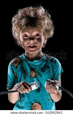 Portrait of funny little electrician over black background