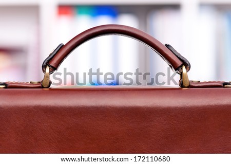 Closeup of brown leather briefcase at office