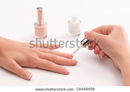 Woman covering her nails with nail polish