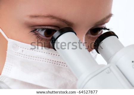 Female medical doctor using microscope in a laboratory on white background