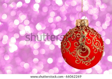 Christmas ball on abstract violet lights as background