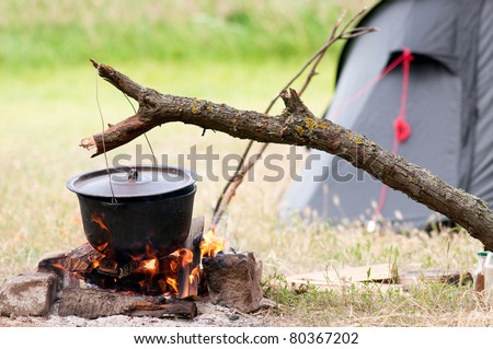 Camping kitchenware - pot on the fire at an outdoor campsite