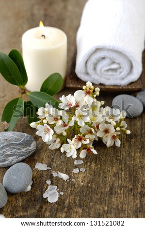 bunch of spring flower, candle, roller towel ,stones on old wood