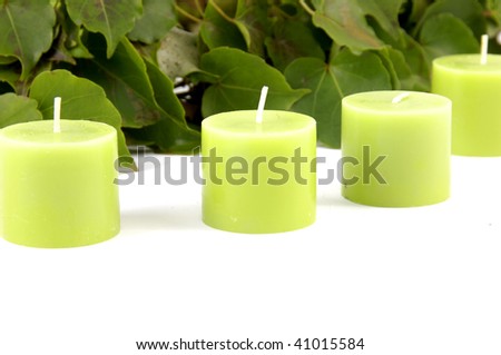 Row of green candle and green leaves