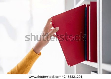 Image, Stock Photo Woman taking books out of cardboox. Unpacking parcel