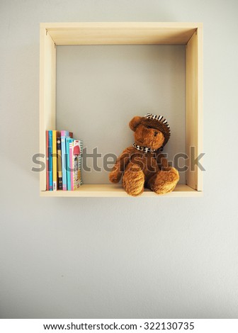 Teddy bear on bookshelf