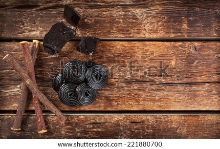 Production steps of licorice, roots, pure blocks and candy on wooden table