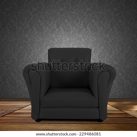 Black armchair isolated in an empty room.