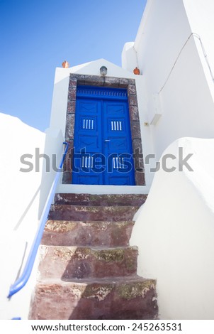 Typical blue door with stairs. Santorini island, Greece.