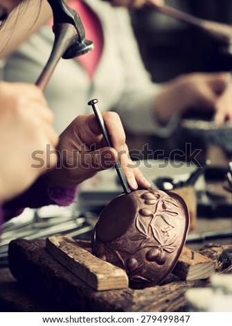 Copper master, hands detail of craftsman at work.