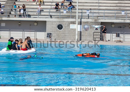 EMPOLI, ITALY - SEPTEMBER 20, 2015: Lifeguard dogs, italian school Cani Salvataggio - S.I.C.S. Rescue demonstration in swimming pool.