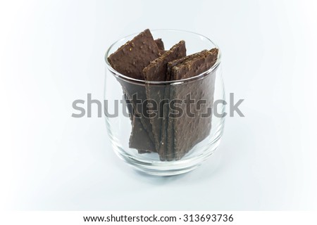 chocolate thin sheet in a clear glass on a white background