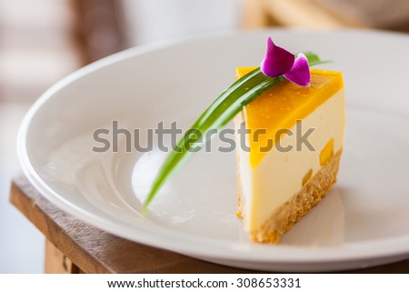 mango mousse cake decorated with pandan and orchid