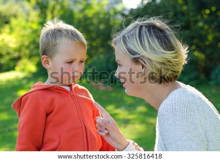 Mother scolds her son crying in the park