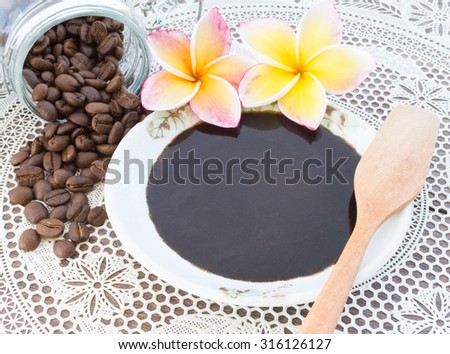 Coffee scrub in a cup with coffee bean, for body and face, nature scrub, on white lace background