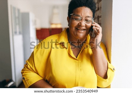Similar – Image, Stock Photo Cheerful black woman talking on smartphone near sea in sunset