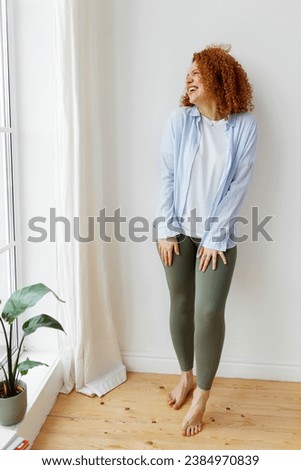 Similar – Image, Stock Photo Cheerful barefoot ginger woman waking up on bed