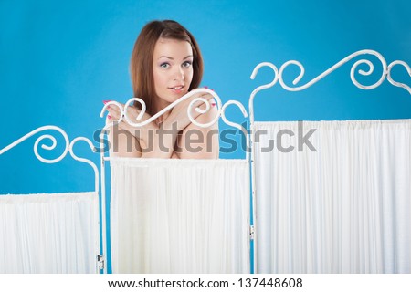 girl changes clothes behind a screen