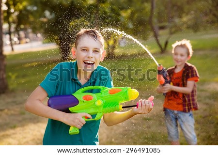 happy boys playing with water guns