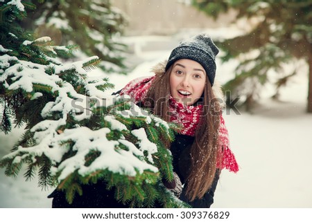 portrait of a sweet girl with a red scarf Christmas in the winter forest