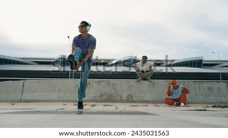 Similar – Image, Stock Photo Skillful break dancer performing handstand while moving