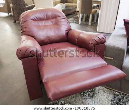 Red leather reclining armchair in furniture show room