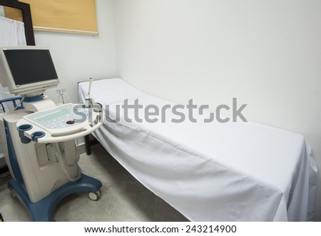 Examination bed with ultrasound scanner machine in medical center hospital