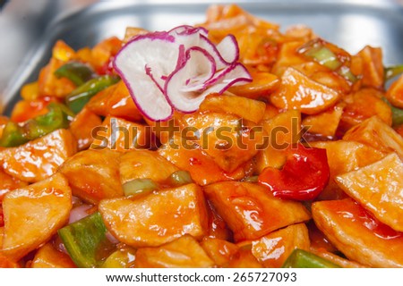 Closeup of chinese sweet chilli potatoes meal on display at a hotel restaurant buffet