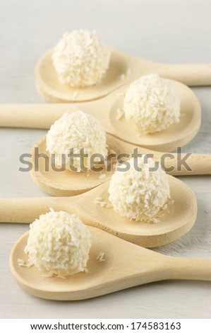 Coconut candies in wooden spoons.