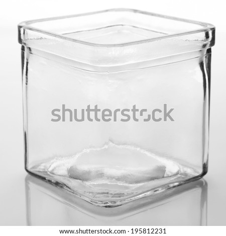 Empty glass jar on light background.