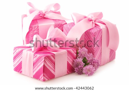 Three pink gifts with satin bows and bouquet of chrysanthemums isolated on white background.