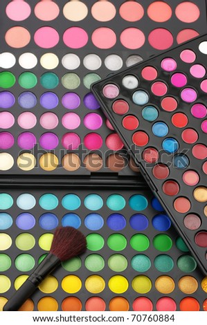 Set of various eye shadows palettes with brush.