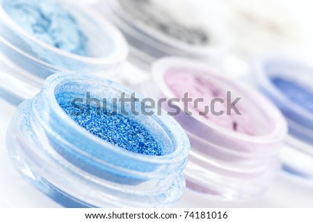 Set of powder eye shadows in jars close-up.