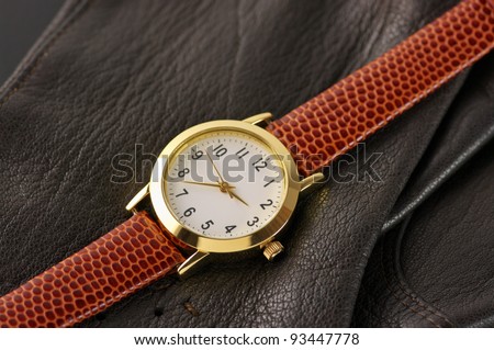 Classical wrist watch with leather accessory.