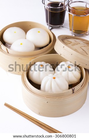 chinese steamed buns with tea and black coffee on white background