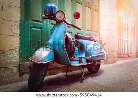 Image, Stock Photo Classic green Vespa Scooter parked in the sidewalk.