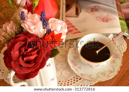Coffee time with flowers and magazine