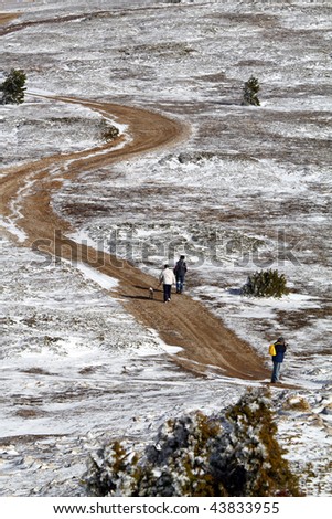 Man walking his dog in winter and a photographer. Javalambre sky run.Teruel province.Aragon.Spain
