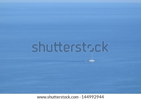 Sailboat on Vast Open Ocean on a Sunny Day