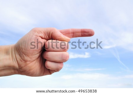 Hand Pointing to the Right Against a Blue Sky